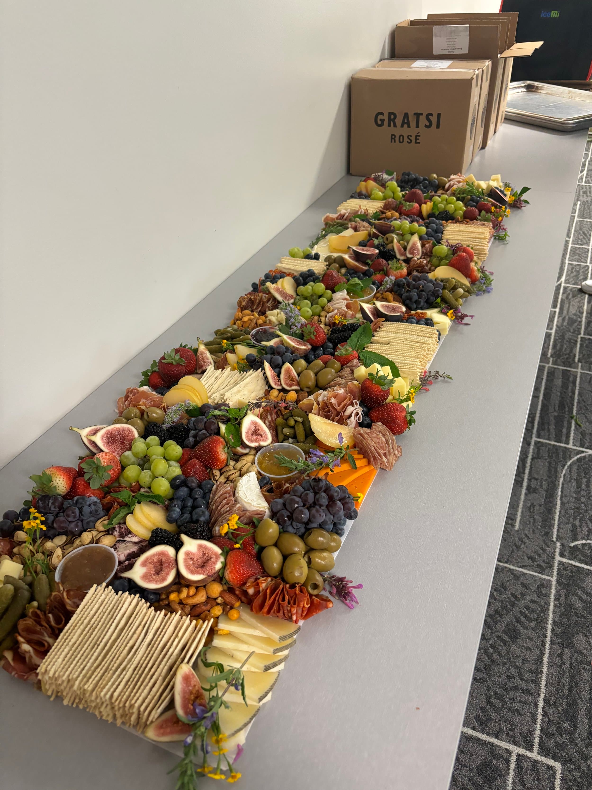 Luxury corporate grazing table installation with artisanal cheeses and premium charcuterie for boardroom events