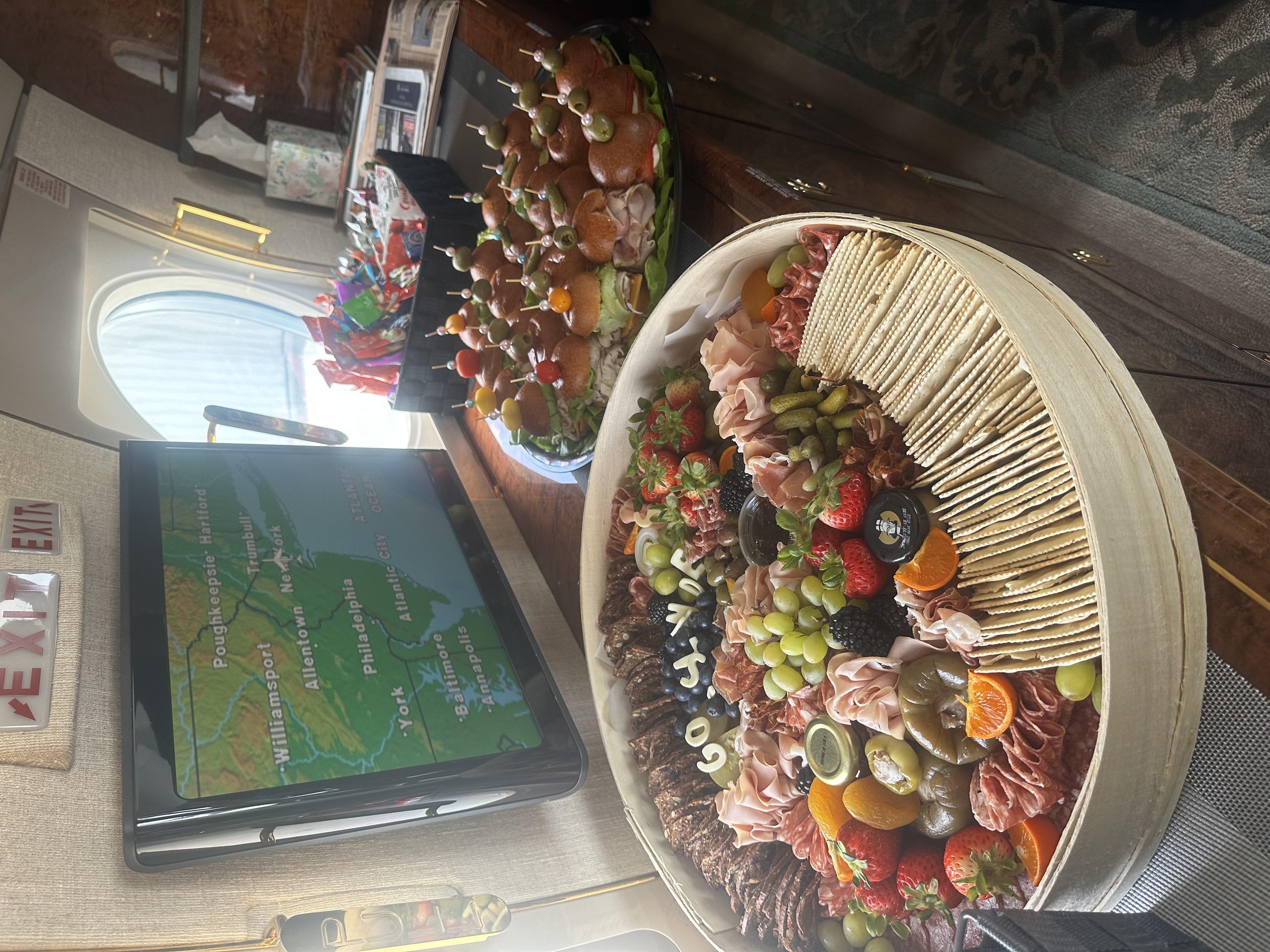 Luxury corporate jet catering featuring an artisanal grazing board and gourmet sliders for executive aviation in NJ and NYC