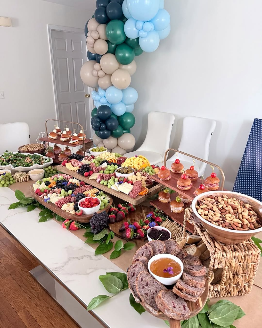 A grand grazing spread with balloons built for a large-scale corporate anniversary celebration at a North Jersey headquarters.